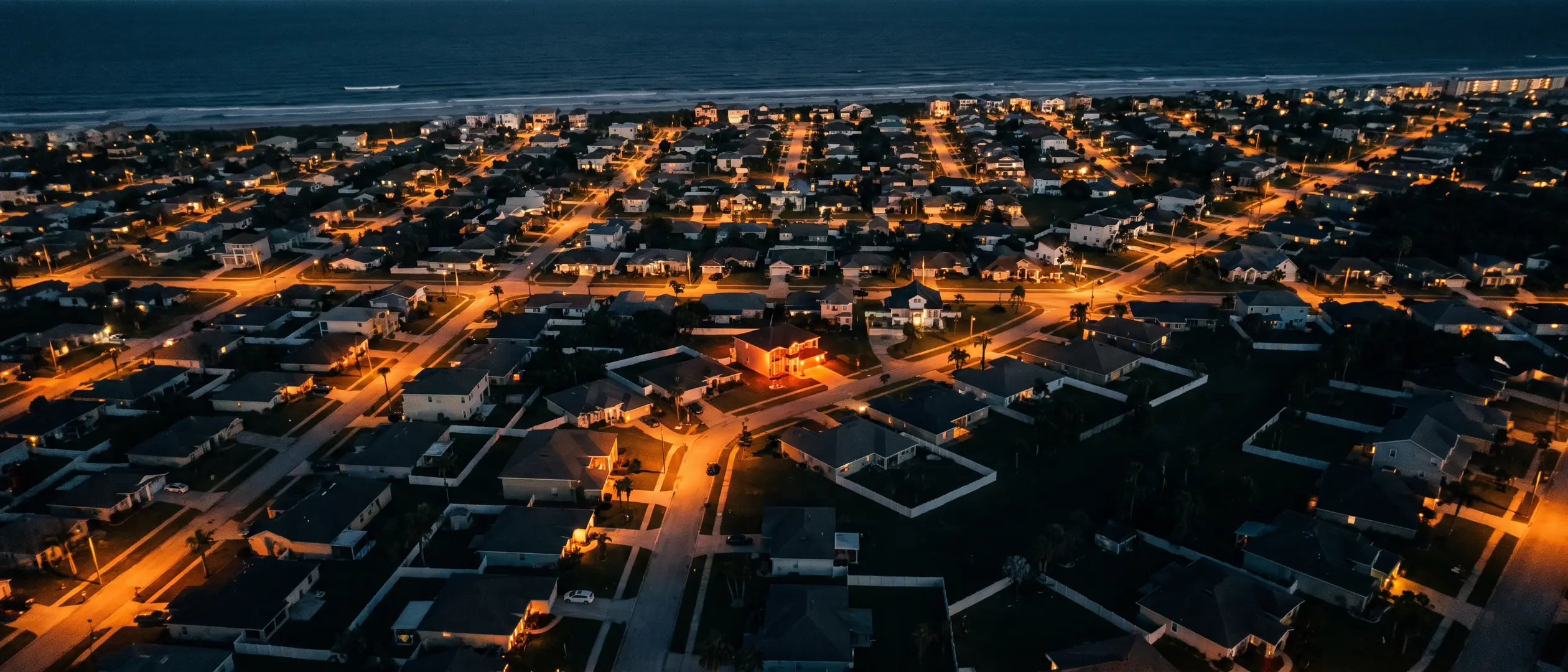 Aerial view of a Volusia County coastal neighborhood at twilight